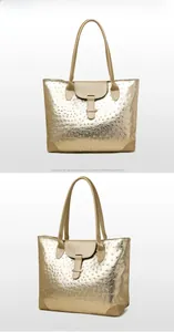 Front and side views of golden tote bag featuring embossed ostrich leather texture