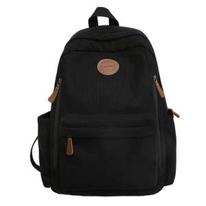 Classic black corduroy backpack with brown leather details and large storage capacity