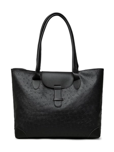 Detail of black ostrich embossed tote bag featuring slim shoulder straps and front flap