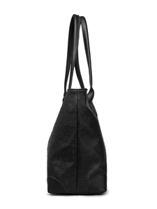 Detailed side profile of black ostrich-embossed leather tote bag with long shoulder straps
