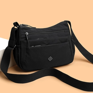 Black high-density nylon multi-pocket crossbody bag with adjustable wide strap and silver logo