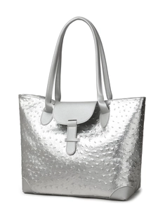 Macro detail of silver ostrich texture faux leather on a large tote bag surface