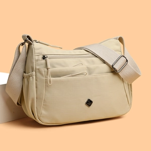 Waterproof beige nylon crossbody bag with multi-layer zipper pockets for daily commute