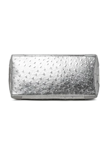 Detail view of the rectangular bottom of the silver tote bag with ostrich leather texture