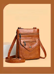 Macro detail of retro brown PU leather shoulder bag with multiple functional zippers