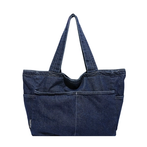 Large vintage navy denim tote bag with functional front pocket and stylish woven labels