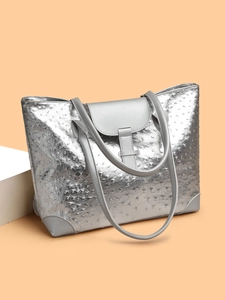 Close-up of silver ostrich texture faux leather tote bag with flap buckle and strap detail