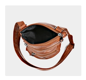 Top view of brown PU leather crossbody bag showing multi-zip layers and black fabric lining