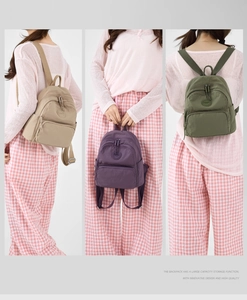 Three-way display of mini nylon backpacks in khaki, purple, and army green colors