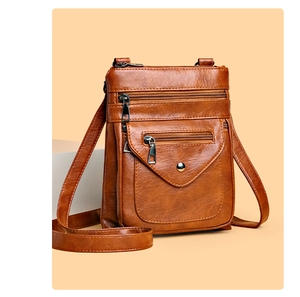 Detailed view of brown vintage crossbody phone bag with multi-zipper pockets and lychee texture