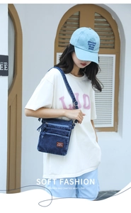 Outdoor shot of a multi-layer denim crossbody bag with brown leather label on model
