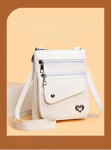 Detail of cream white litchi pattern leather bag with triple zippers and heart logo