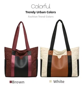 Detail of quilted nylon tote bags in brown and white contrast colors with long handles
