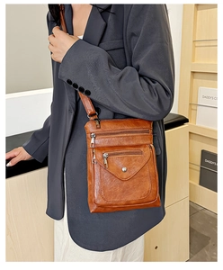 Brown vintage faux leather crossbody bag with multiple zippers and adjustable strap