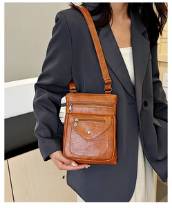 Brown soft leather crossbody phone bag with multi-zipper pockets and adjustable strap