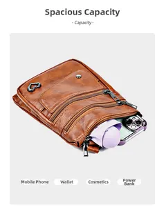 Detail view of brown vintage leather crossbody bag with three zipper pockets and capacity
