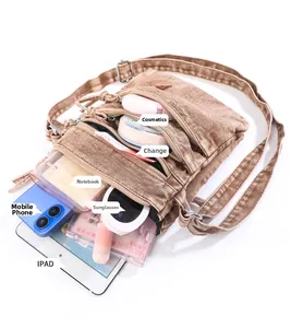 Brown washed denim crossbody bag showing multi-pocket storage for tablet and phone