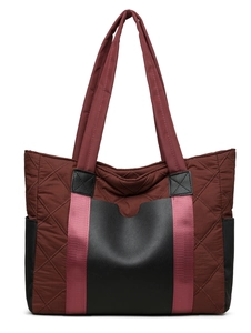 Detail of dark burgundy quilted nylon tote with black faux leather base and purple strap