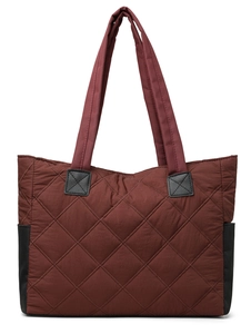 Detail of burgundy quilted nylon tote bag with black strap accents and fine stitching