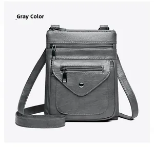 Detailed view of gray PU crossbody phone bag with multi-zipper pockets and litchi texture