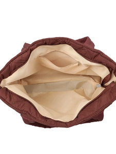 Deep red quilted nylon tote bag showing spacious beige interior and metal zipper pocket
