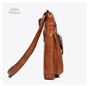 Side view of brown vintage leather crossbody bag showing multi-layer zipper compartments