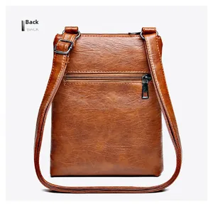 Back view of vintage brown pebbled leather crossbody bag with gunmetal zipper pocket