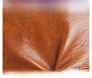Macro detail of high-quality brown leather with natural grain texture and oil finish