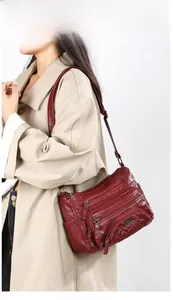 Fashion soft PU leather crossbody bag with multi-pocket design shown on model
