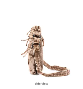 Side view of multi-compartment washed canvas crossbody bag in vintage tan with metal zippers