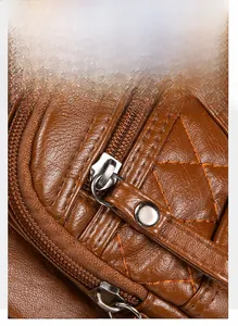 Detailed macro view of quilted brown leather bag featuring durable gold-plated metal zipper