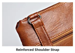 Detail of reinforced shoulder strap with metal D-ring and stitching on brown leather bag