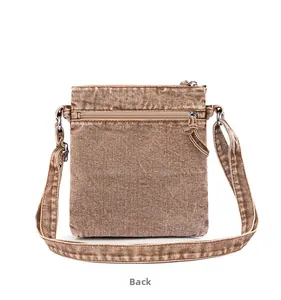Detail view of the back of the vintage washed denim crossbody bag with zipper pocket