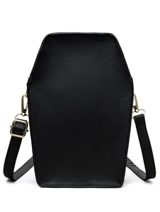 Macro shot of coffin-shaped cross-grain faux leather bag with gold gothic hardware