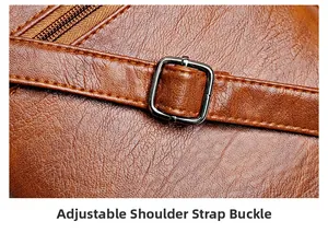 Detail of adjustable gunmetal buckle and pebble leather texture on brown crossbody bag