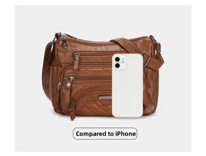 Brown soft leather crossbody bag size comparison with an iPhone for scale reference