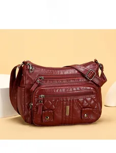 Macro detail of wine red washed faux leather shoulder bag with quilted diamond pattern