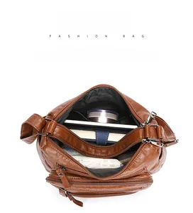 Top view of brown soft leather crossbody bag showing multiple pockets and large capacity