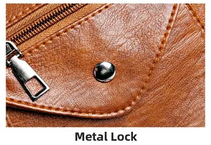 Macro detail of brown litchi pattern leather bag with silver hardware clasp and zipper