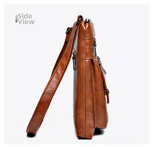 Side view of vintage brown leather crossbody bag with multi-layer zippers and lychee texture