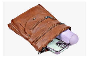 Detail showing internal capacity for phone and umbrella in brown faux leather crossbody bag