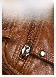 Detail of silver metal zippers on brown washed leather shoulder bag with fine stitching
