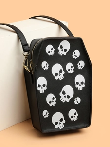 Detail of coffin-shaped crossbody bag with white skull prints and gold zipper hardware