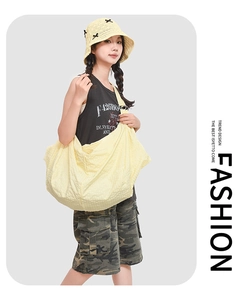 Detailed view of yellow water-resistant shoulder bag with bubble texture and large capacity