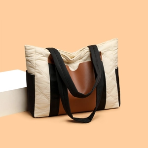 Quilted beige nylon tote bag with contrasting brown leather trim and top handles