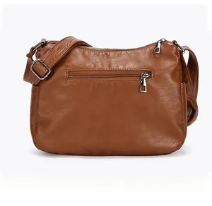 Rear view of brown soft faux leather shoulder bag featuring silver-tone zipper pocket