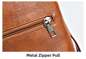 Macro detail of gunmetal gray brushed metal zipper on brown pebble leather crossbody bag