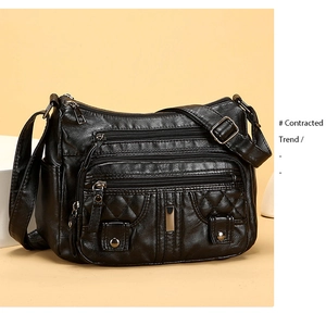 Close-up of black washed soft leather shoulder bag with multiple zippers and quilting