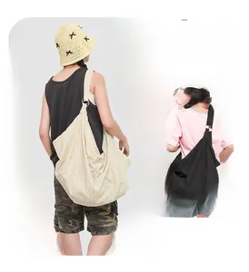 Detail of checkered water-resistant crossbody bag with adjustable metal ring buckle