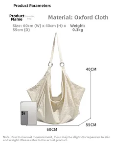Close-up of beige nylon oxford shoulder bag with dimensions 60x40x55cm and metal ring detail